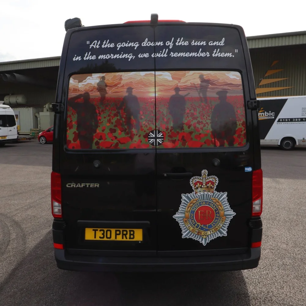 The back of a black VW Crafter LWB with a military graphic.