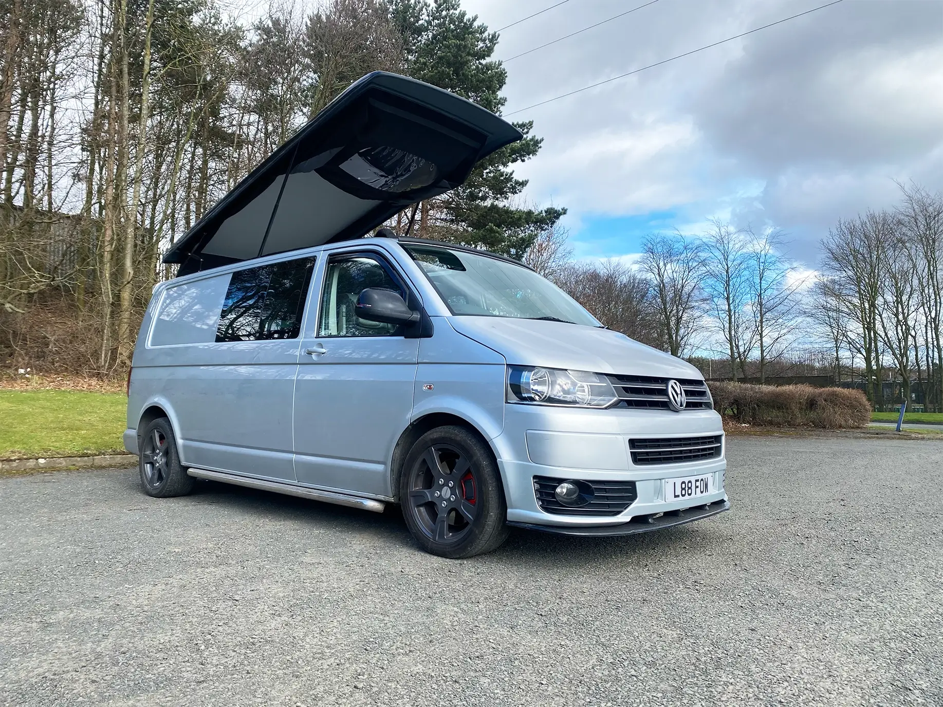 Parked up silver camper with the roof extended