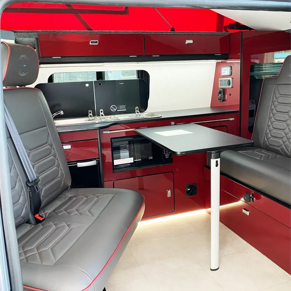 The interior of a camper van with red shelving