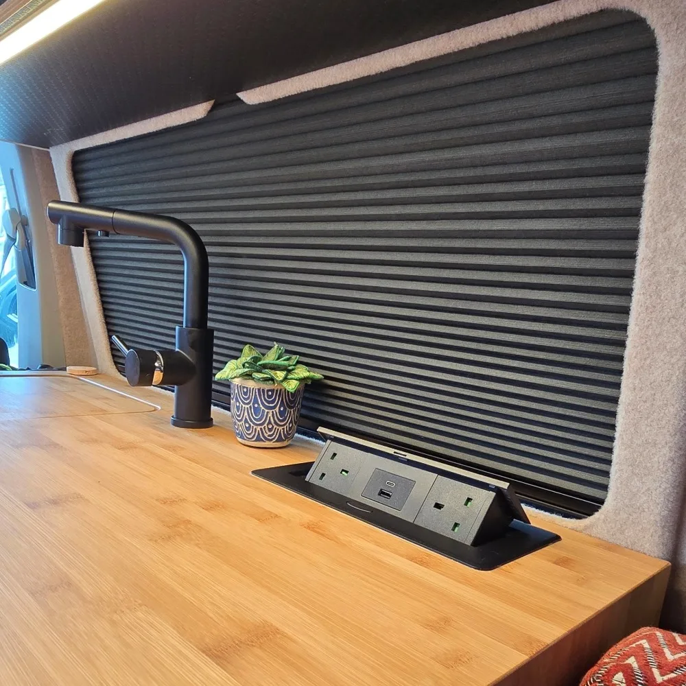 A discrete power socket unit on a wooden bench.