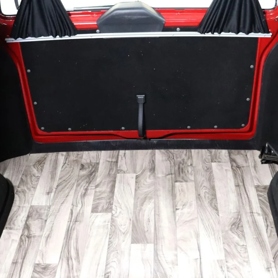 A camper van interior with wood effect flooring.